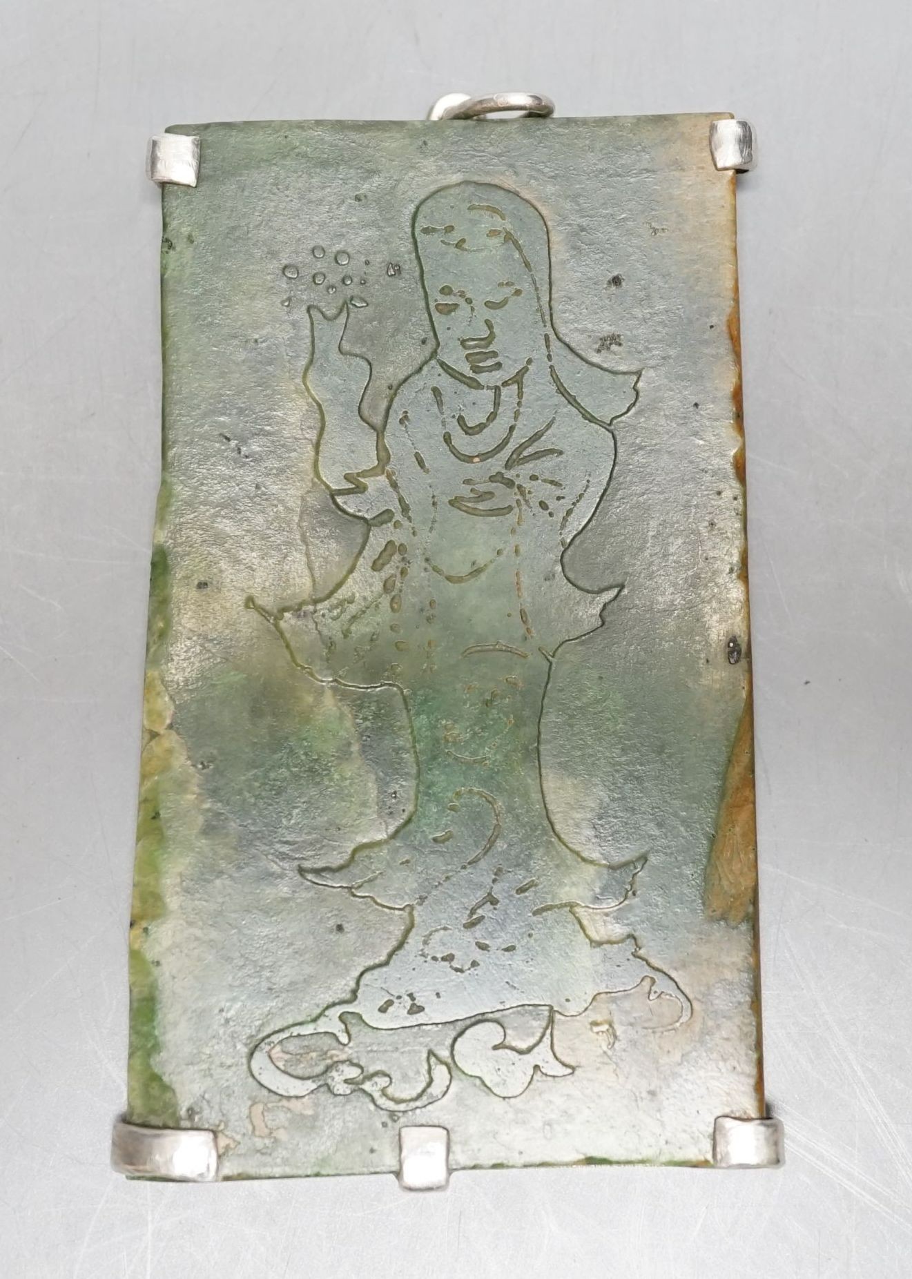 A Chinese carved spinach green jade panel, 9cms high.